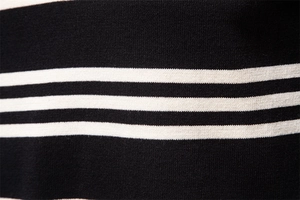 Macro shot of black and white striped knit fabric showing detailed needlework texture