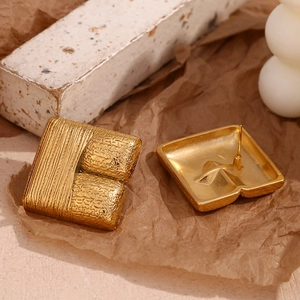 Detailed close-up of vintage square 18K gold-plated stainless steel stud earrings with texture