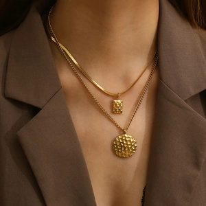 Double-layered gold titanium necklace featuring honeycomb and square geometric pendants