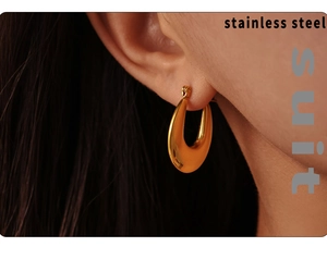 Close-up of 18K gold-plated stainless steel U-shaped earring on model ear