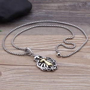 Detail of hip hop stainless steel necklace with hollow silver cross and gold sword pendant