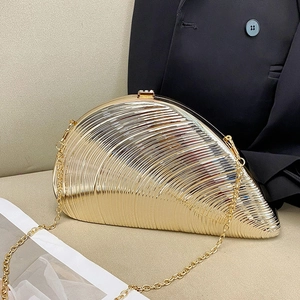 Golden shell-shaped acrylic evening clutch bag with metal texture and chain strap