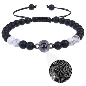 Detail of couple bracelets with matte stone beads and 100 languages I Love You projection