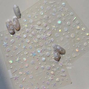 Detail of 3D holographic shell nail stickers with iridescent ocean starfish and seashell motifs