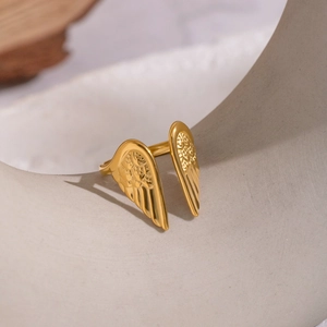 Detailed macro shot of 18K gold plated angel wing ring with fine feather textures