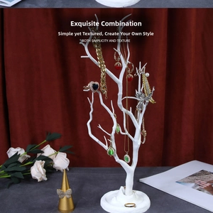 White tree-shaped jewelry organizer stand with branches for necklaces and earring storage