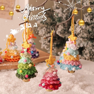 Handmade crochet Christmas tree ornaments with colorful pom-poms and stars on branches
