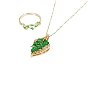 Elegant gold-plated leaf jewelry set with green gemstones and white crystals