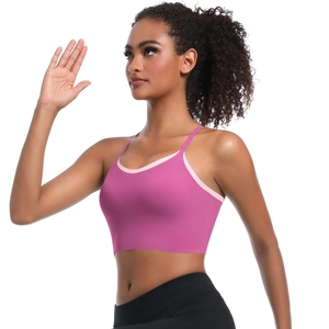 Detail of rose pink sports bra with contrast light pink piping and slim shoulder straps