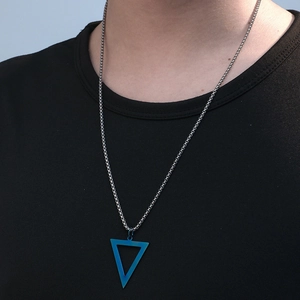 Detail of male model wearing black triangle pendant necklace with blue gradient on box chain