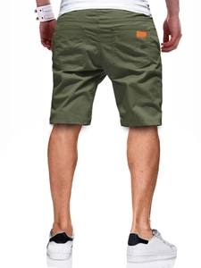 Detail view of olive green casual shorts for men featuring rear pockets and tailored cut