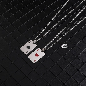 Detailed view of silver curb chains and Ace of Spades and Hearts poker card pendants