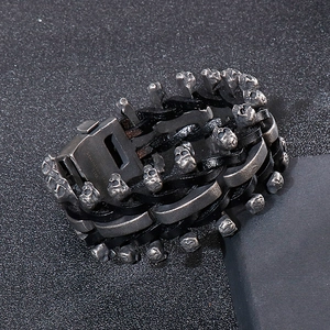 Detail of 316L stainless steel skull charm and braided leather strap on biker bracelet