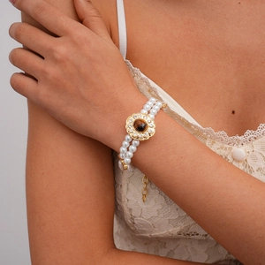 Detail of double-layer pearl bracelet featuring sunflower tiger eye stone and crystals