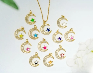 Macro detail of 18K gold plated moon and star pendants with colorful zircon inlay