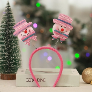 Close-up of pink Christmas headband featuring twin spring snowmen for festive party decor