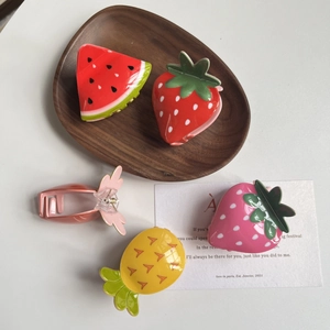 Cute acrylic fruit hair claws featuring watermelon, strawberry, and pineapple designs