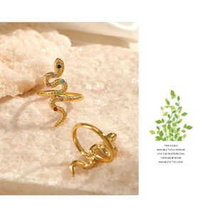 Macro view of gold snake rings featuring multi-color zircon stones and scale texture