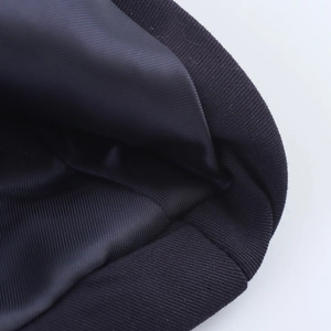 Detail of black ribbed knit fabric with smooth inner lining and premium stitching