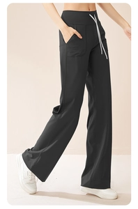 Detail view of high waist black yoga pants with white drawstring and side pockets