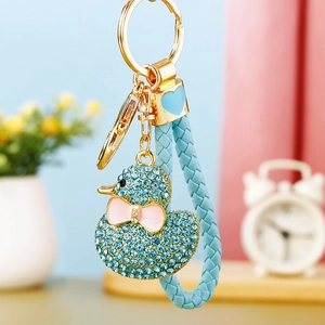 Detail of light blue rhinestone duck keychain with woven strap and golden metal ring