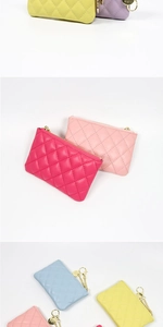 Macro view of multi-color quilted PU leather coin purses with golden zippers and keyrings