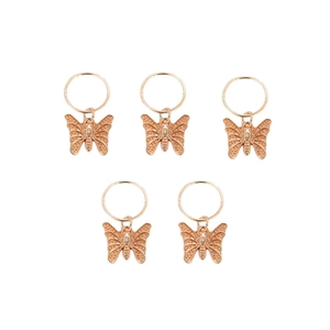 Five gold metal butterfly charm hair rings for dreadlocks hair decoration on white background