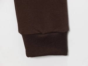 Close-up of dark coffee knit ribbed cuffs and hem texture on a long sleeve fleece set