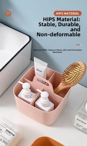 Close-up of pink plastic organizer with four compartments and handle on bathroom counter