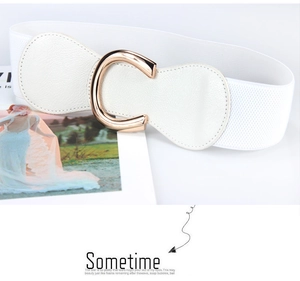 Detail of white elastic waist belt featuring a polished gold C-shaped metal buckle