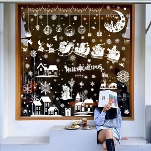 White Christmas window decals with Santa and reindeer on a store glass storefront