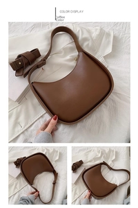 Vue détaillée d'un sac selle en cuir marron avec design incurvé et bandoulière réglable