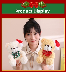 Close-up of Christmas teddy bear plush toys with festive red hats and bows in hand
