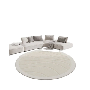 Minimalist white round rug with wavy patterns under a modern L-shaped sectional sofa