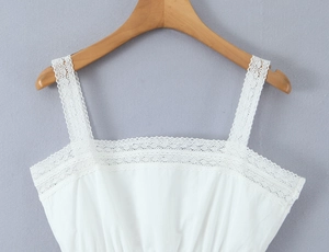 Close-up of white lace shoulder straps and bodice detail on a French style summer top