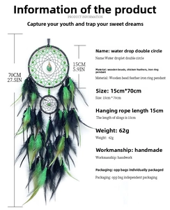 Detail view of a handmade dream catcher featuring green and black feathers and wood beads