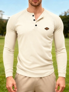 Detail of waffle knit fabric and three-button placket on men's off-white Henley shirt