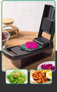 Macro detail of manual food chopper cutting dragon fruit into cubes with green blade frame