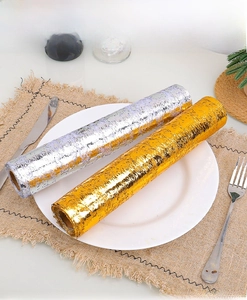 Detail showing gold and silver textured metallic table runners in a dining setup