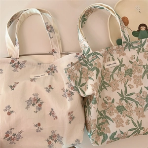 Detail of floral cotton handbags featuring vintage French style and a simple wish label