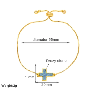 Detail showing adjustable gold cross bracelet with blue druzy stone and size dimensions