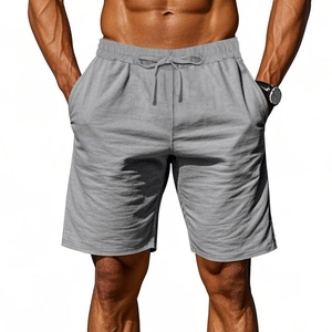 Detail view of men's grey linen shorts featuring drawstring elastic waist and cotton texture