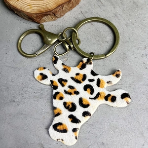 Close-up of leopard print bull head keychain with vintage brass metal buckle and chain
