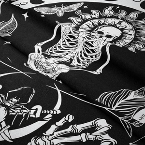Detailed macro view of gothic moth and skull patterns on soft black velvet tapestry