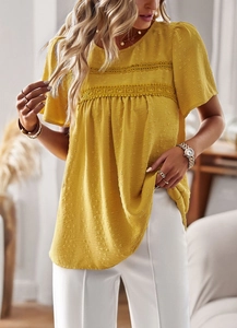 Detail of the yellow textured top featuring lace patchwork and delicate polka dots