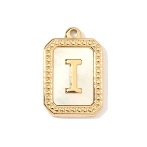Macro view of a rectangular gold letter I pendant with white shell inlay and beaded edges