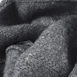 Thick dark gray knit beanie with warm textured wool material for winter outdoor wear
