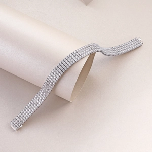 Elegant silver five-row tennis bracelet with micro-pave crystals on a white pillar