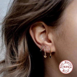 S925 sterling silver gold earrings set with black gemstones and star pendant on model