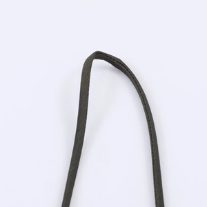 Detail of olive green woven fabric shoulder strap with neat stitching on white background